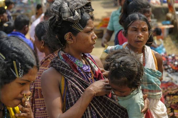 Dongria Kondh women in traditional shawls and hair clips at a weekly market